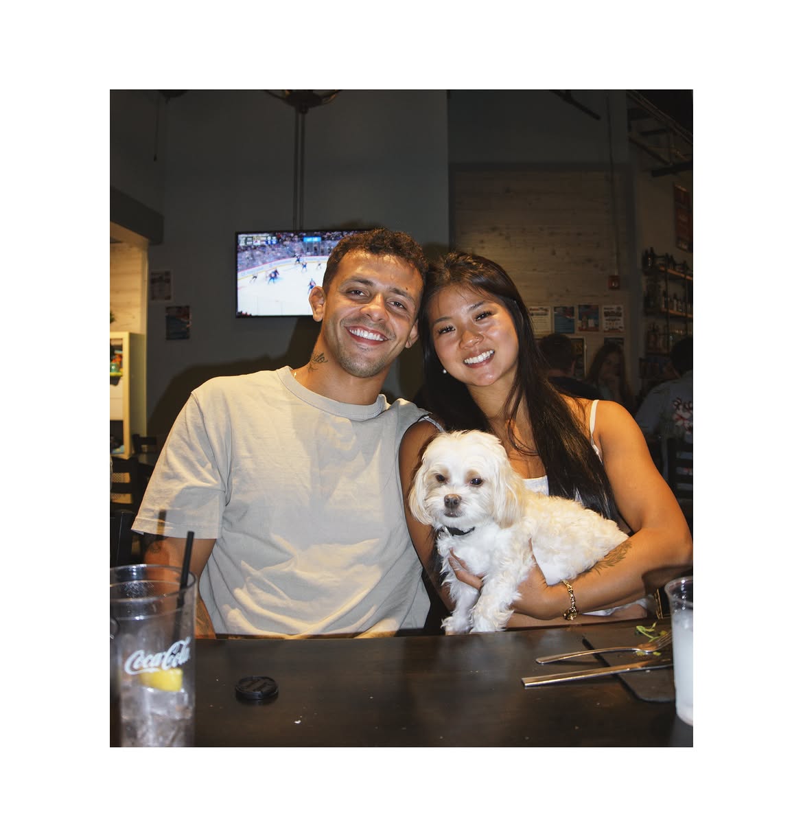 Two Traktion members smiling with their dog during a team night out