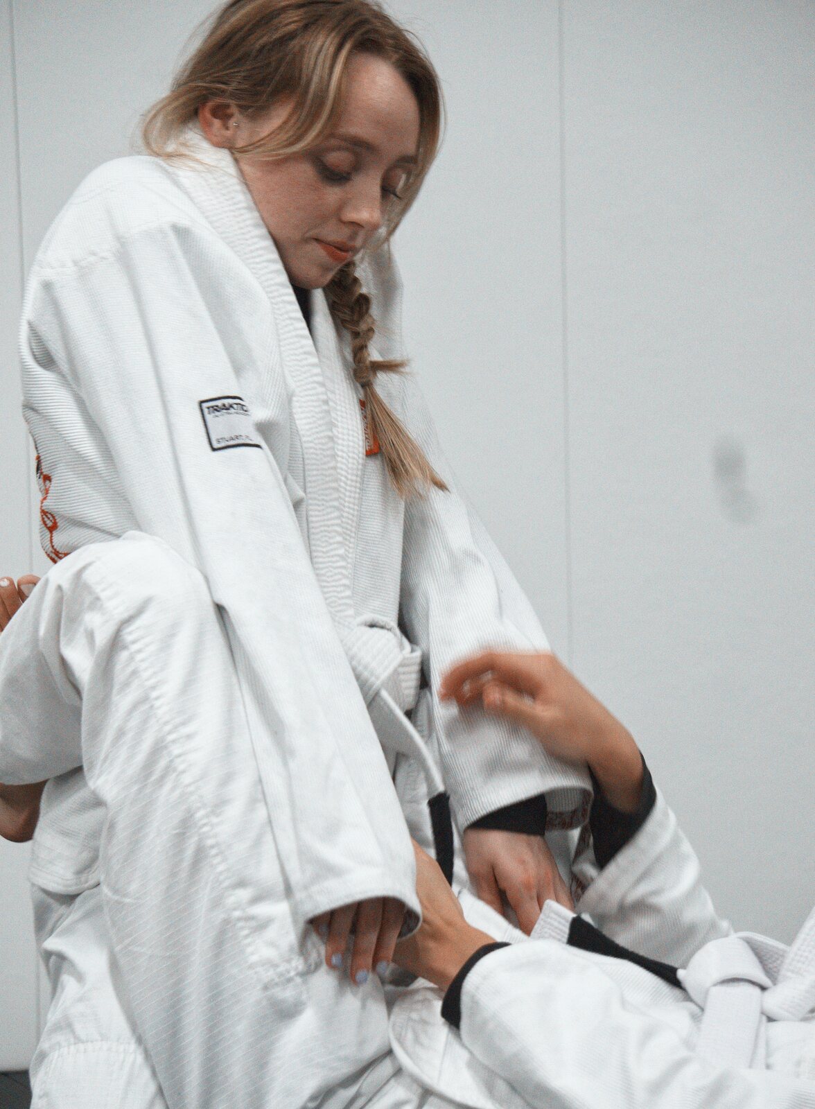 Adult students practising positional sparring on the academy mats