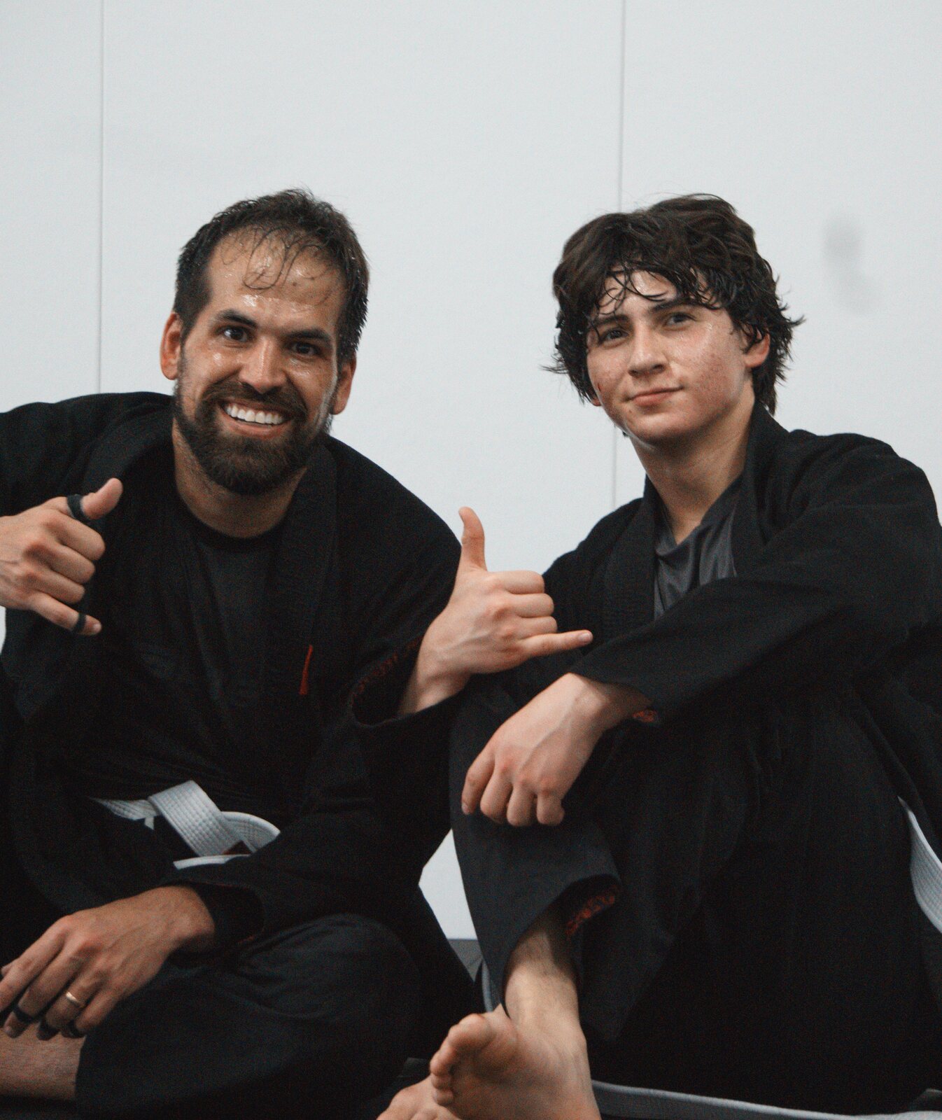 Adults training together during an evening jiu jitsu session