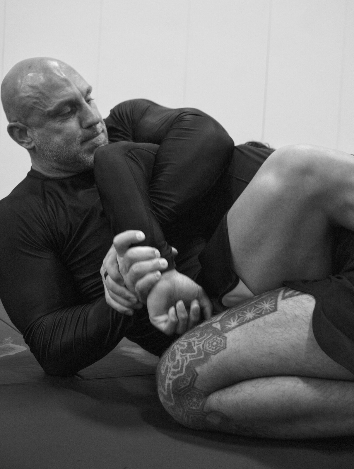 Adult practitioner working a submission during a no-gi round