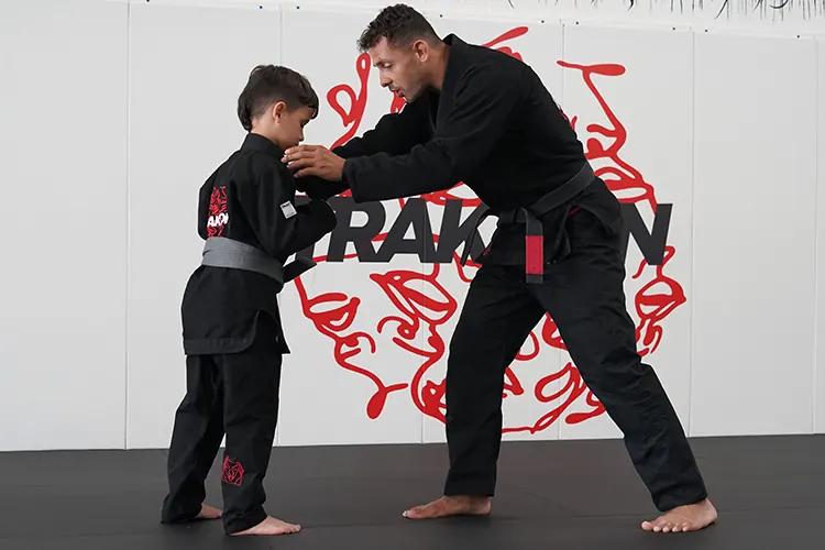 Adult student receiving one-to-one jiu jitsu coaching in a private class